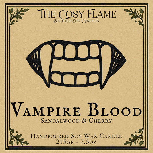 Vampire Blood candle label design by The Cosy Flame, featuring an illustration of a vampire mouth with fangs, featuring the scents sandalwood and cherry.